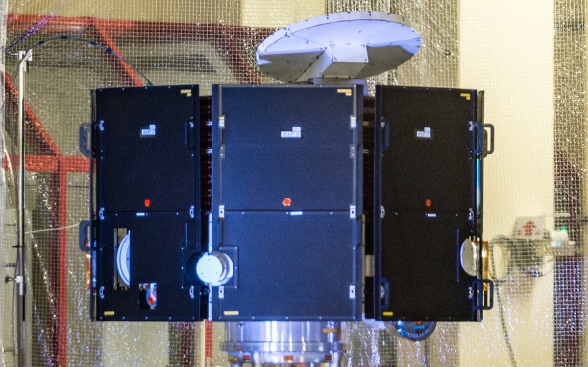The Mio spacecraft in a clean room at ESTEC before launch, its dark octagonal body and wire-antenna hatches visible